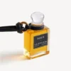 Colgante con frasco de perfume en miniatura en color negro