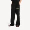 Pantalones de chándal holgados de hombre con estampado de spray desordenado en negro Pantalones de chándal holgados de hombre con estampado de spray desordenado en negro