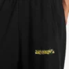 Pantalones de chándal holgados de hombre con estampado de spray desordenado en negro Pantalones de chándal holgados de hombre con estampado de spray desordenado en negro